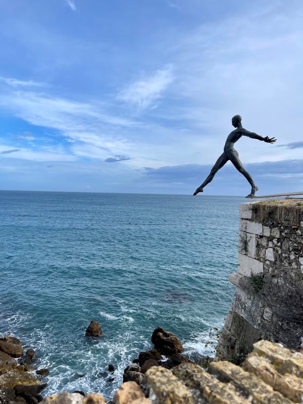 man woman. bronze sculpture on top of the ocean