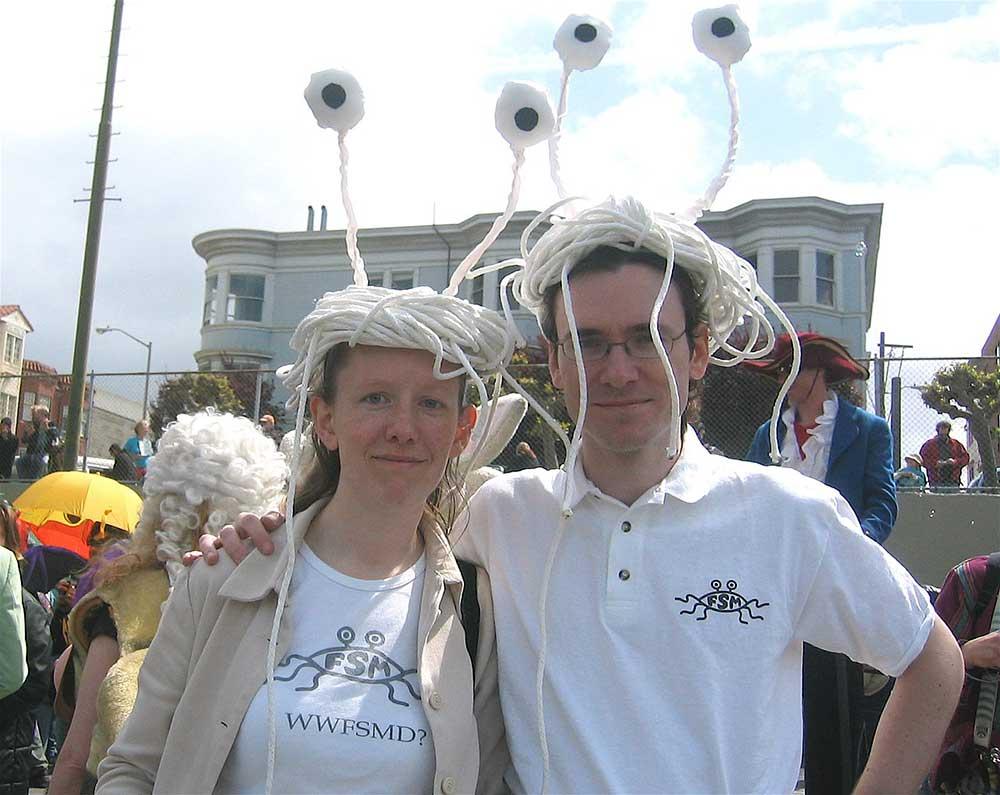 a couple celebrating san fancisco saint stupid's day parade in flying spaghetti monsters headpiece