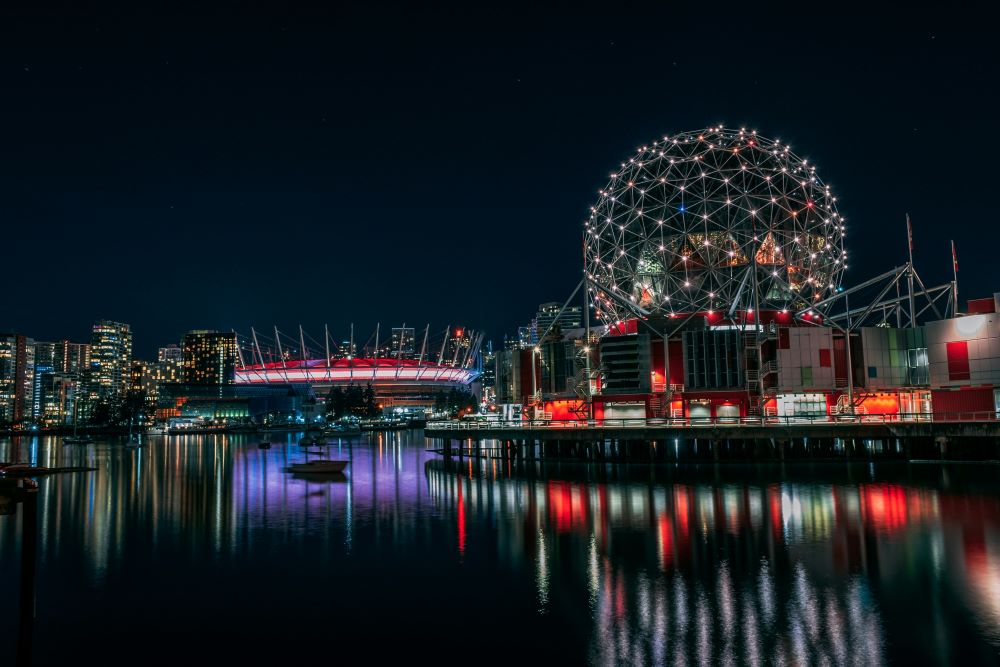 circle structure on top of a building beside body of water
