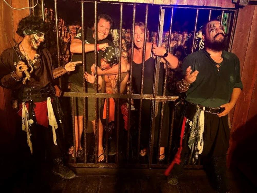 my husband and I being taking picture in a jail with pirates