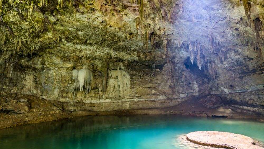 inside the cave with stone pathway that leads to the center of the cenote