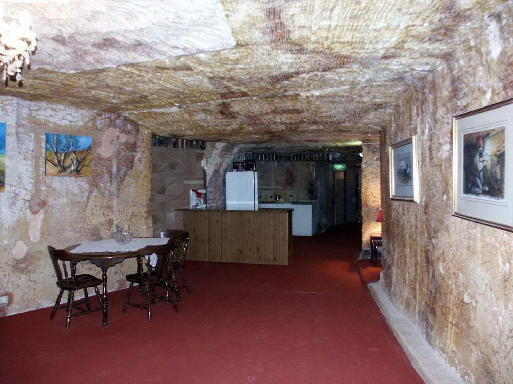 table and chairs in a room underground - Underground Attractions