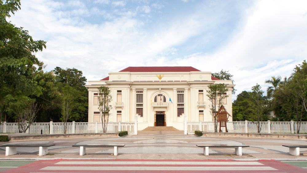 white building with red roof surrounded by green trees- things to do in chiang mai