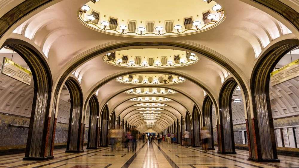 soaring pillars adorned with intricate mosaics and chandeliers that illuminate the space with a warm, inviting glow.