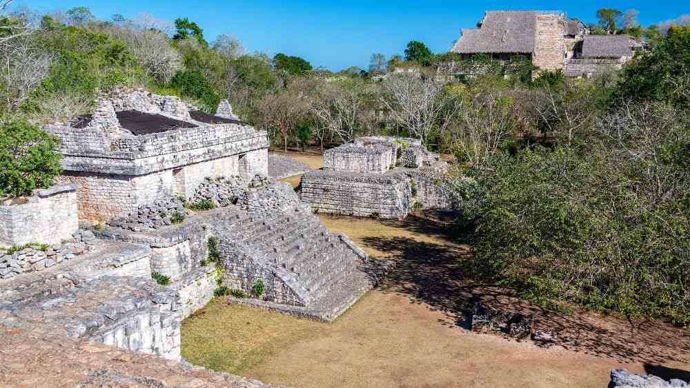aerial view of the ruins made of stone surrounded by green trees- Amazing Things to Do in Mexico's Yucatan Peninsula