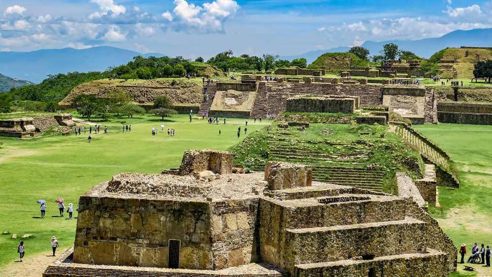 aerial view of the Monte Albán with people walking around the large pre-Columbian archaeological site in Oaxaca, Mexico