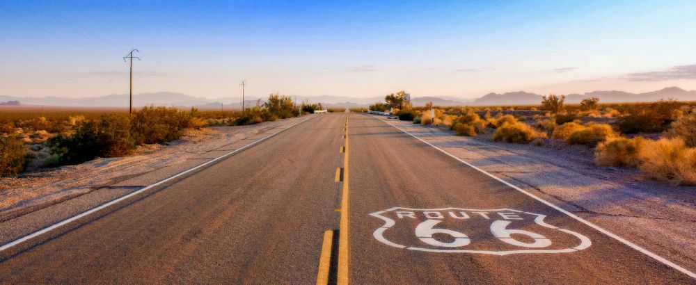 Road with Route 66 White Signage at the road floor - Best road trips in the world