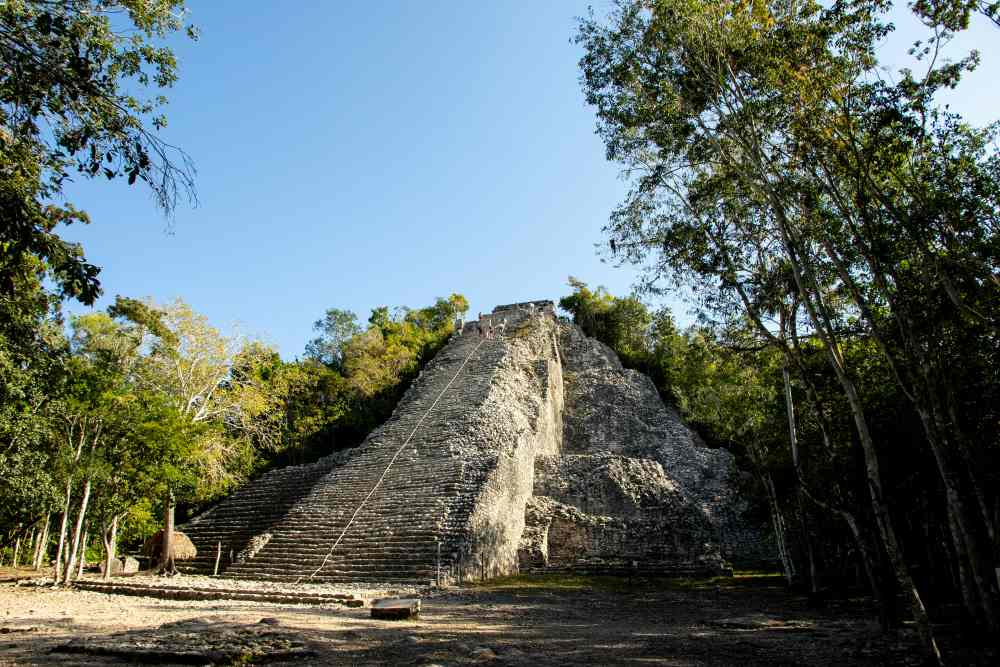 stone mountain like building in the middle of the jungle