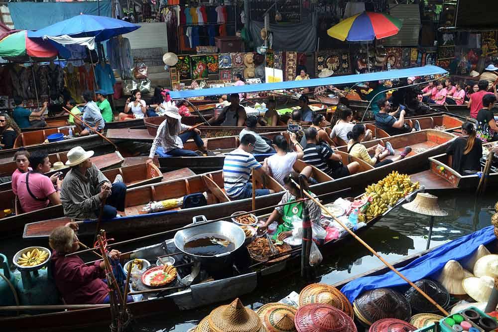 bunch of people inside a boat in the famous floating market